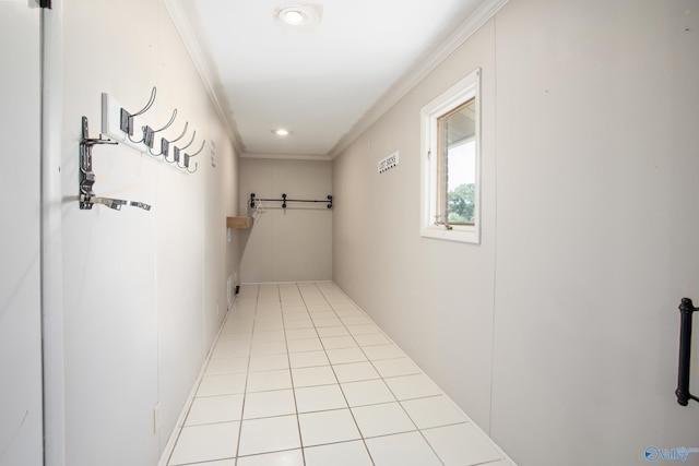 corridor with light tile patterned flooring and crown molding