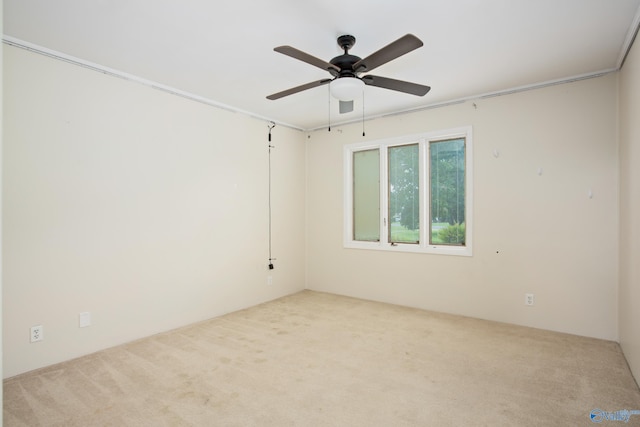 empty room featuring light carpet and ceiling fan