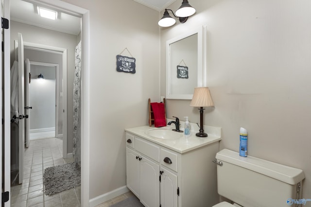 bathroom featuring tile patterned flooring, toilet, ornamental molding, and vanity