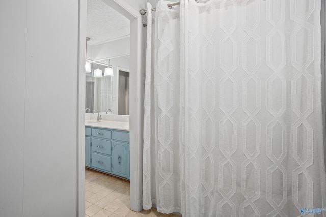 bathroom featuring vanity and a textured ceiling