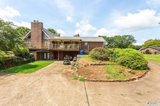 back of property featuring a wooden deck