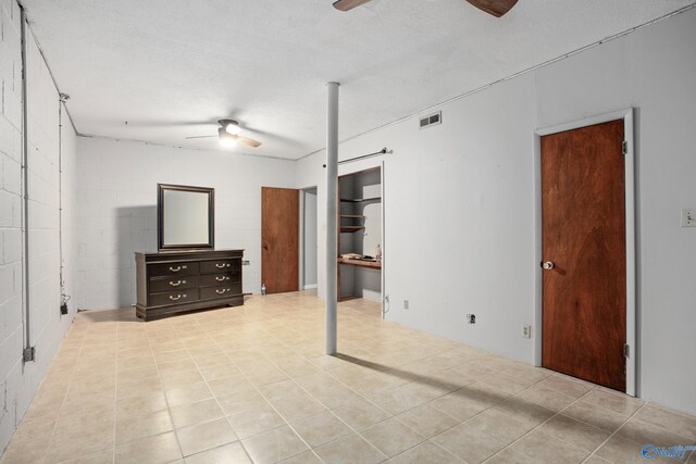 interior space featuring ceiling fan and a textured ceiling