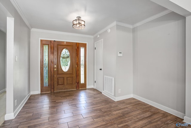 entryway featuring a chandelier, dark hardwood / wood-style flooring, and ornamental molding