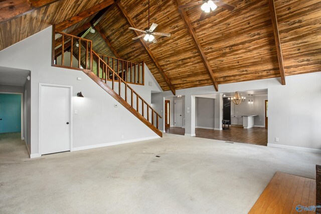 living room featuring high vaulted ceiling, ceiling fan with notable chandelier, and light carpet