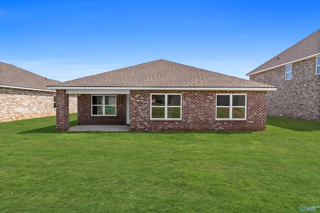 rear view of property featuring a patio and a lawn