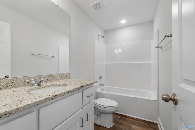 full bathroom with vanity, hardwood / wood-style flooring, shower / washtub combination, and toilet