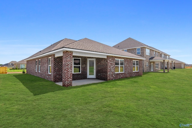 back of house featuring a patio and a yard