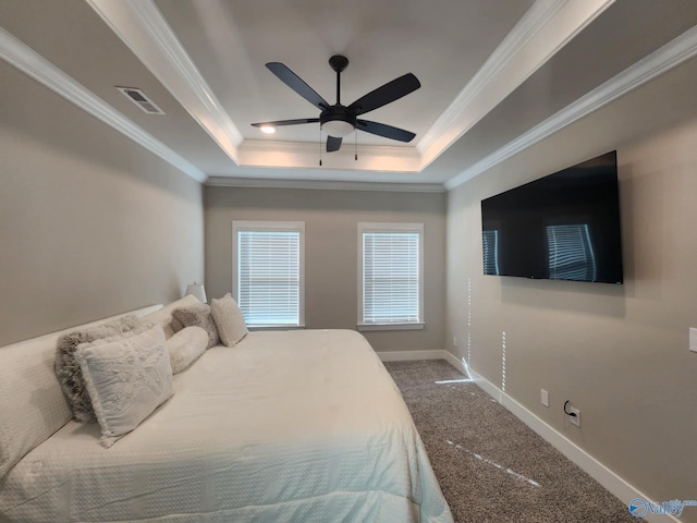 bedroom featuring ceiling fan, a tray ceiling, carpet, and ornamental molding