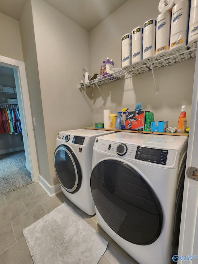 washroom featuring washer and clothes dryer and light tile patterned floors