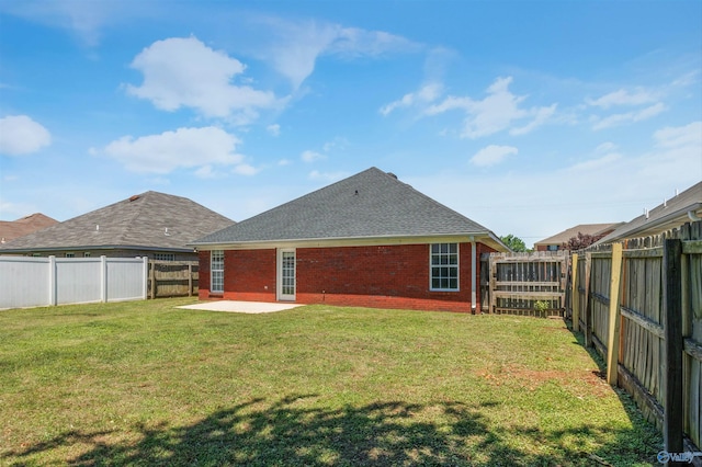 1417 Smith Ave SW, Decatur, AL 35603 - back of property with a patio, brick siding, and a shingled roof
