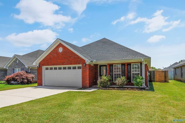 1417 Smith Ave SW, Decatur, AL 35603 - traditional-style house featuring brick siding, an attached garage, driveway, and roof with shingles