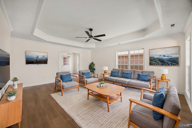 1417 Smith Ave SW, Decatur, AL 35603 - living room featuring a raised ceiling, wood finished floors, ceiling fan, crown molding, and baseboards