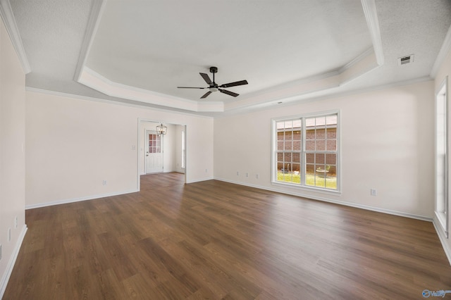 1417 Smith Ave SW, Decatur, AL 35603 - spare room featuring a tray ceiling, a ceiling fan, wood finished floors, ornamental molding, and baseboards