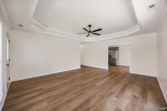 1417 Smith Ave SW, Decatur, AL 35603 - empty room featuring a raised ceiling, a ceiling fan, wood finished floors, crown molding, and baseboards