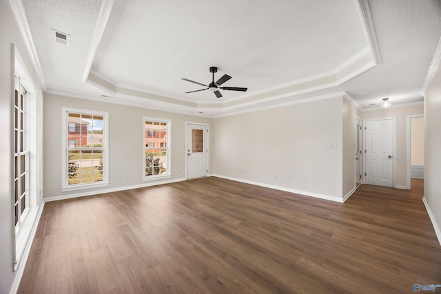 1417 Smith Ave SW, Decatur, AL 35603 - empty room featuring a tray ceiling, ornamental molding, a ceiling fan, dark wood-style flooring, and baseboards