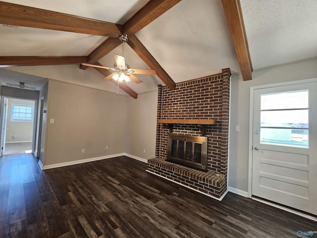 unfurnished living room featuring dark hardwood / wood-style flooring, a brick fireplace, lofted ceiling with beams, and a textured ceiling