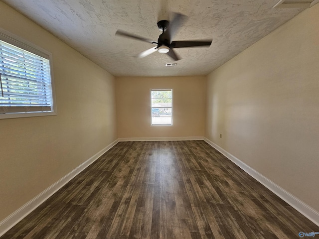 unfurnished room with dark hardwood / wood-style flooring, ceiling fan, and a textured ceiling