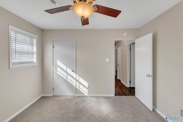 unfurnished bedroom featuring carpet flooring, a ceiling fan, and baseboards