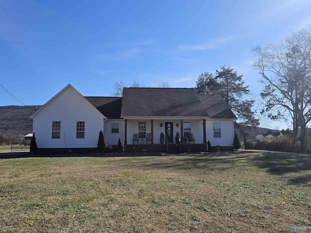 ranch-style house featuring a porch and a front yard