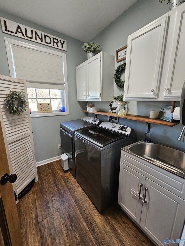 laundry room with independent washer and dryer, cabinet space, dark wood-style floors, and baseboards
