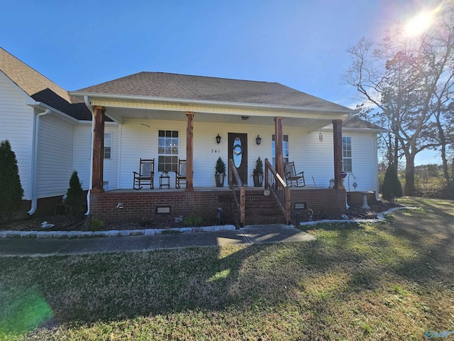 bungalow featuring covered porch, a front yard, and crawl space