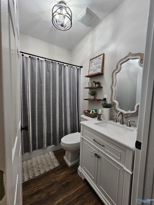 bathroom with wood finished floors, toilet, vanity, and a shower with shower curtain