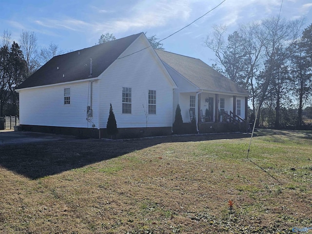 back of house with a porch and a lawn
