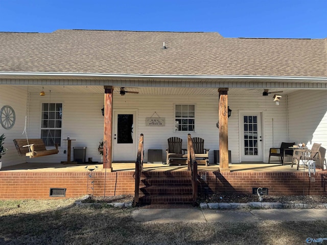 property entrance with a porch, ceiling fan, and roof with shingles