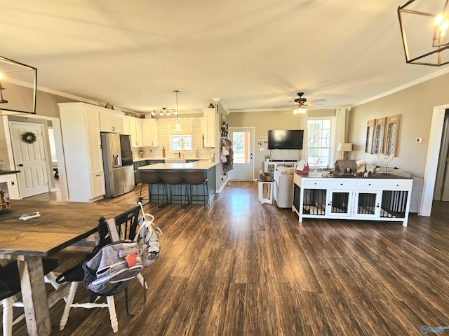 dining space featuring ornamental molding, dark wood-style floors, and ceiling fan