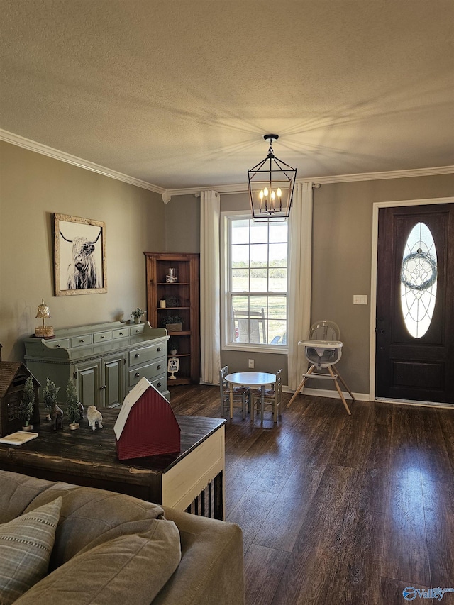 living area featuring a chandelier, dark wood-style flooring, crown molding, baseboards, and a textured ceiling