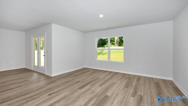 unfurnished room with light hardwood / wood-style floors