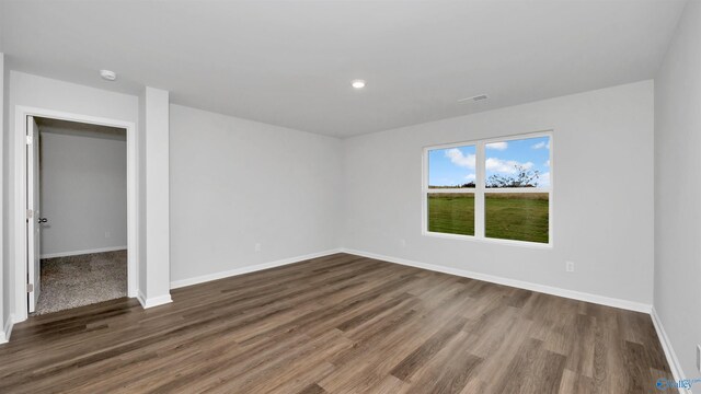 empty room featuring dark hardwood / wood-style flooring