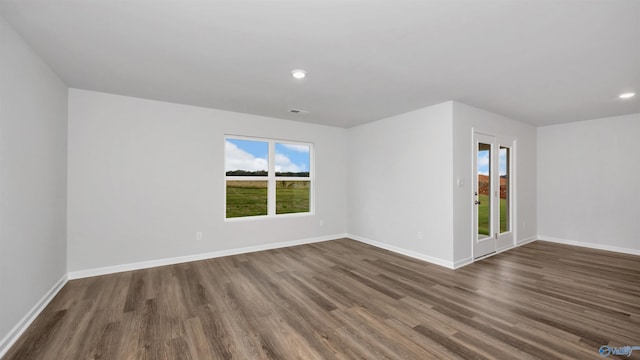 spare room with dark wood-type flooring