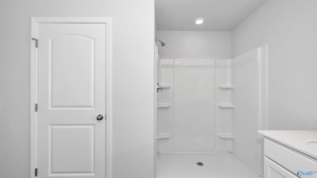 bathroom with vanity and a shower