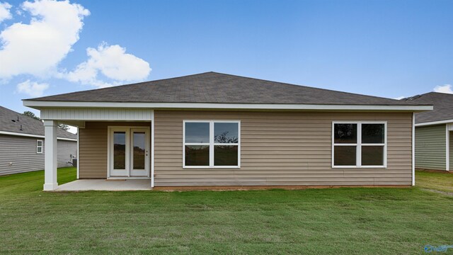 rear view of house with a yard and a patio