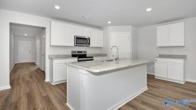 kitchen featuring appliances with stainless steel finishes, a center island with sink, white cabinetry, and sink