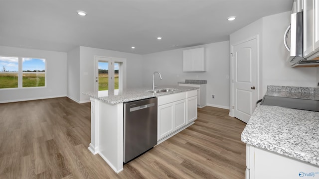 kitchen with a kitchen island with sink, appliances with stainless steel finishes, a sink, and white cabinetry