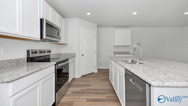 kitchen featuring sink, white cabinets, stainless steel appliances, and light hardwood / wood-style floors