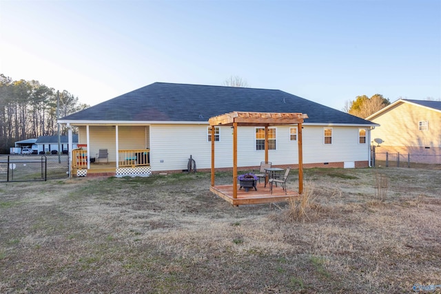 back of house featuring a pergola and a lawn