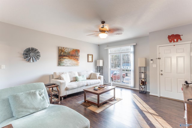 living room featuring ceiling fan and dark hardwood / wood-style floors