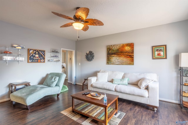 living room featuring dark wood-type flooring and ceiling fan