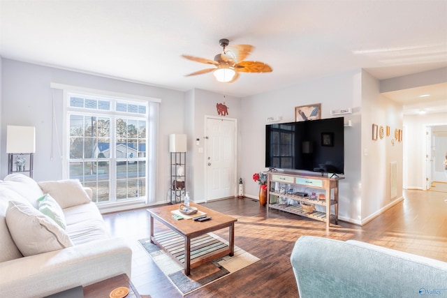 living room with dark hardwood / wood-style flooring and ceiling fan