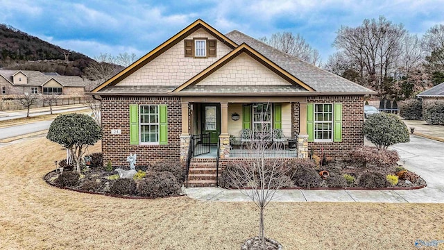 view of front of house with a porch and a front lawn