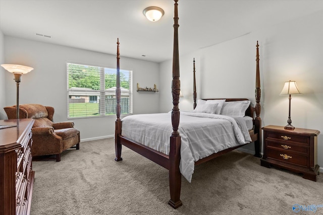 bedroom featuring light colored carpet and baseboards
