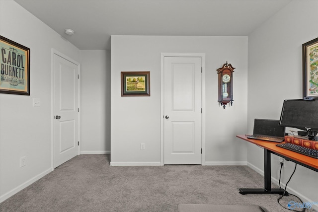 carpeted office featuring baseboards