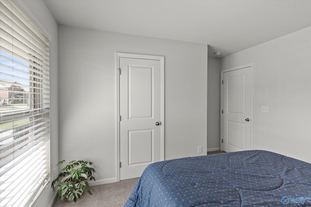 bedroom with carpet flooring and baseboards