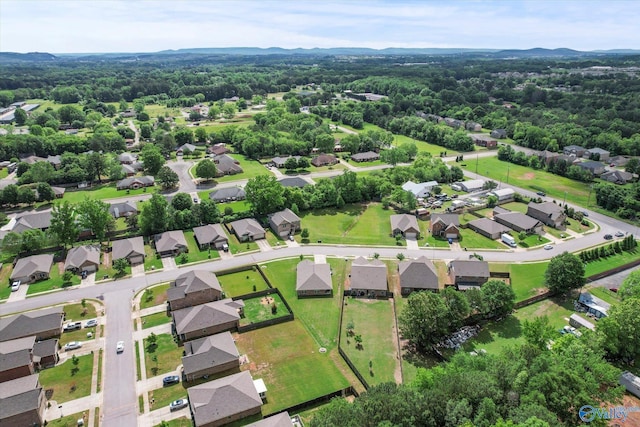 aerial overview of property's location with nearby suburban area and a heavily wooded area