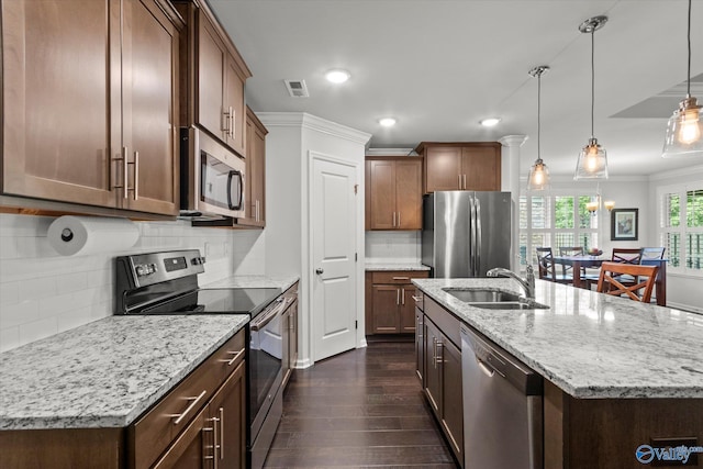 kitchen with appliances with stainless steel finishes, a sink, dark wood-style floors, recessed lighting, and ornamental molding