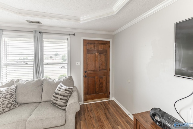 entrance foyer featuring a tray ceiling, dark wood-type flooring, a textured ceiling, and crown molding
