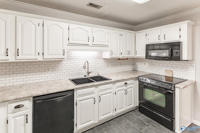 kitchen with white cabinets, black appliances, dark tile patterned flooring, decorative backsplash, and sink